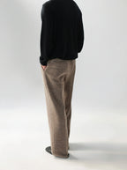 Mayfairloom minimalist wool trousers shown on a model, featuring a sleek, tailored design with a high-waist fit and clean lines.