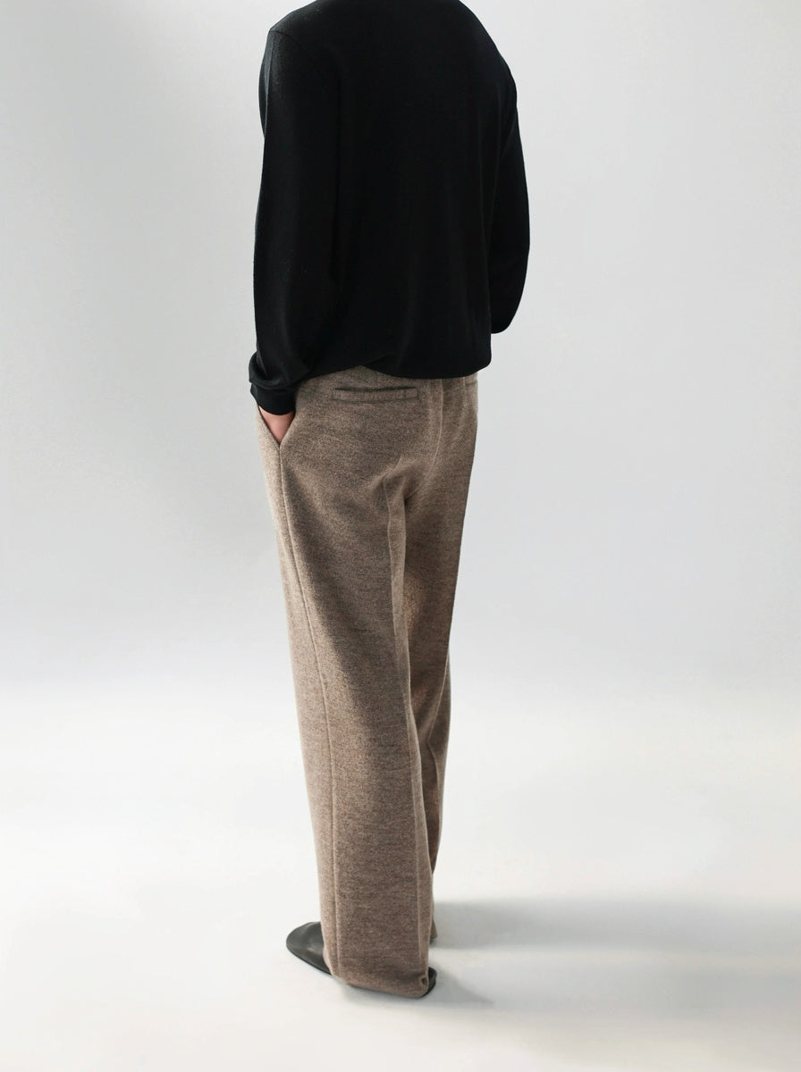 Mayfairloom minimalist wool trousers shown on a model, featuring a sleek, tailored design with a high-waist fit and clean lines.