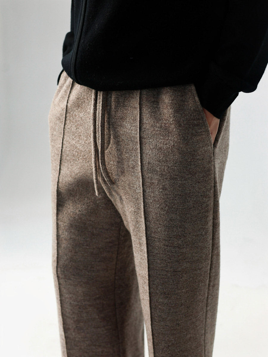Mayfairloom minimalist wool pants displayed flat, showcasing their sleek, effortless design and clean lines in soft wool fabric.