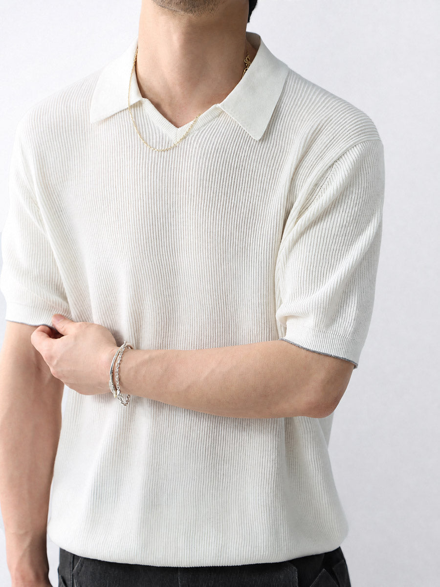 Mayfairloom Gullwing V-Neck Knit Polo shirt displayed on a hanger, featuring a classic V-neck and textured knit fabric.