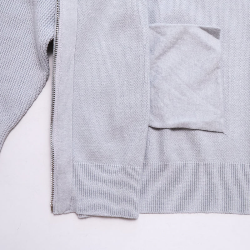 Light grey Marlow cardigan by mayfairloom displayed on a hanger, showcasing its soft knit fabric and classic design.