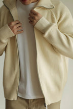 Mayfairloom modal high-neck knit cardigan hanging on a wooden hanger, showcasing soft fabric and fitted design.