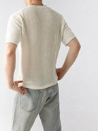 Mayfairloom Bruges Linen Knit Tee shown in natural beige with a relaxed fit and short sleeves, styled casually on a wooden background.