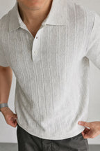 Mayfairloom Marlow Knit Polo shirt in navy with ribbed collar and cuffs, displayed on a hanger against a neutral background.