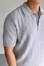 Mayfairloom Marlow Knit Polo shirt in navy with ribbed collar and cuffs, displayed on a hanger against a neutral background.