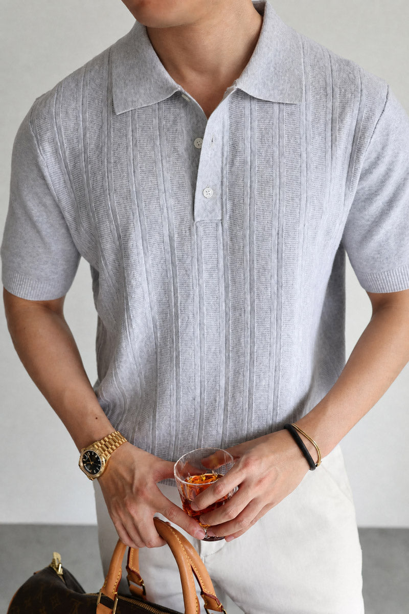 Mayfairloom Marlow Knit Polo shirt in navy, featuring a classic collar and textured knit fabric, displayed on a hanger.